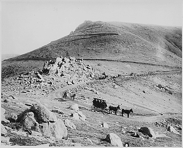 Buckboard and coaches zigzagging down the "W" Pike's Peak carriage road, Colorado, 1911